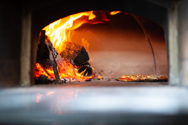 Mod Pizza stone-fire oven baking pizzas fresh